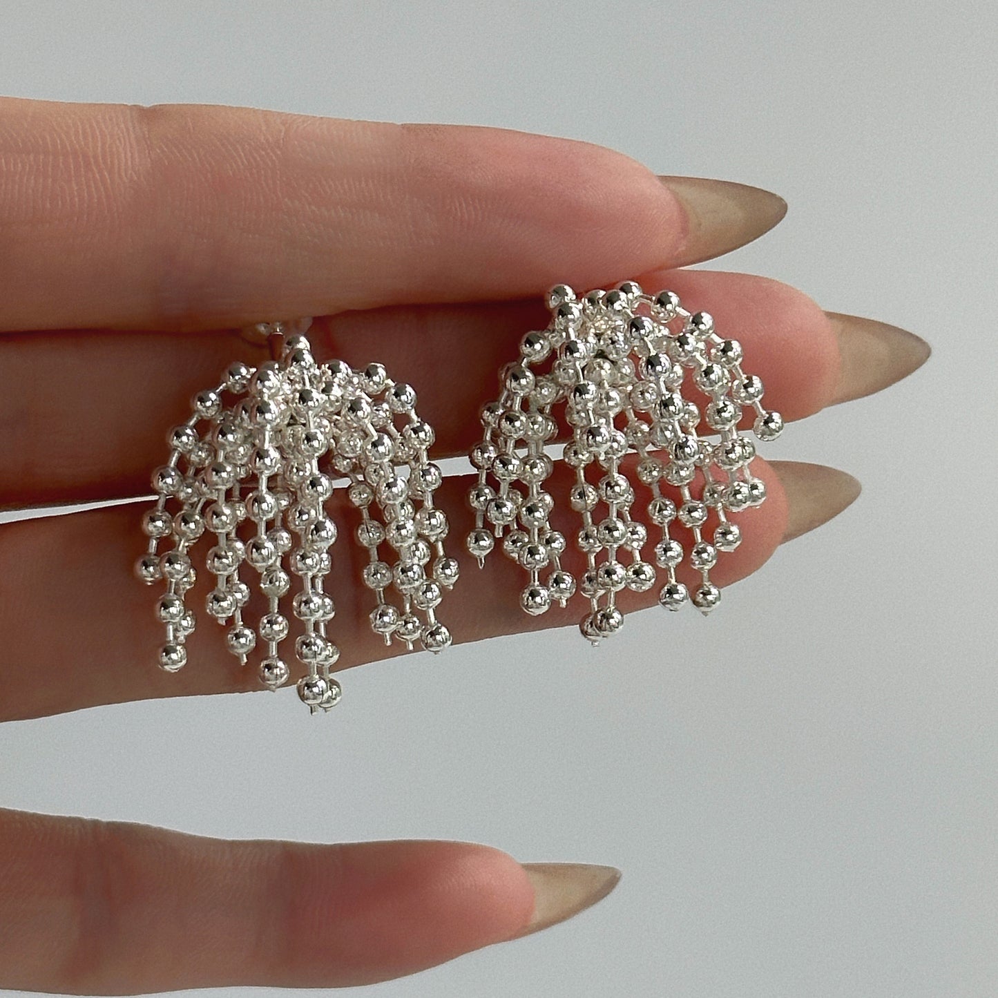 Polished bead fringed earrings