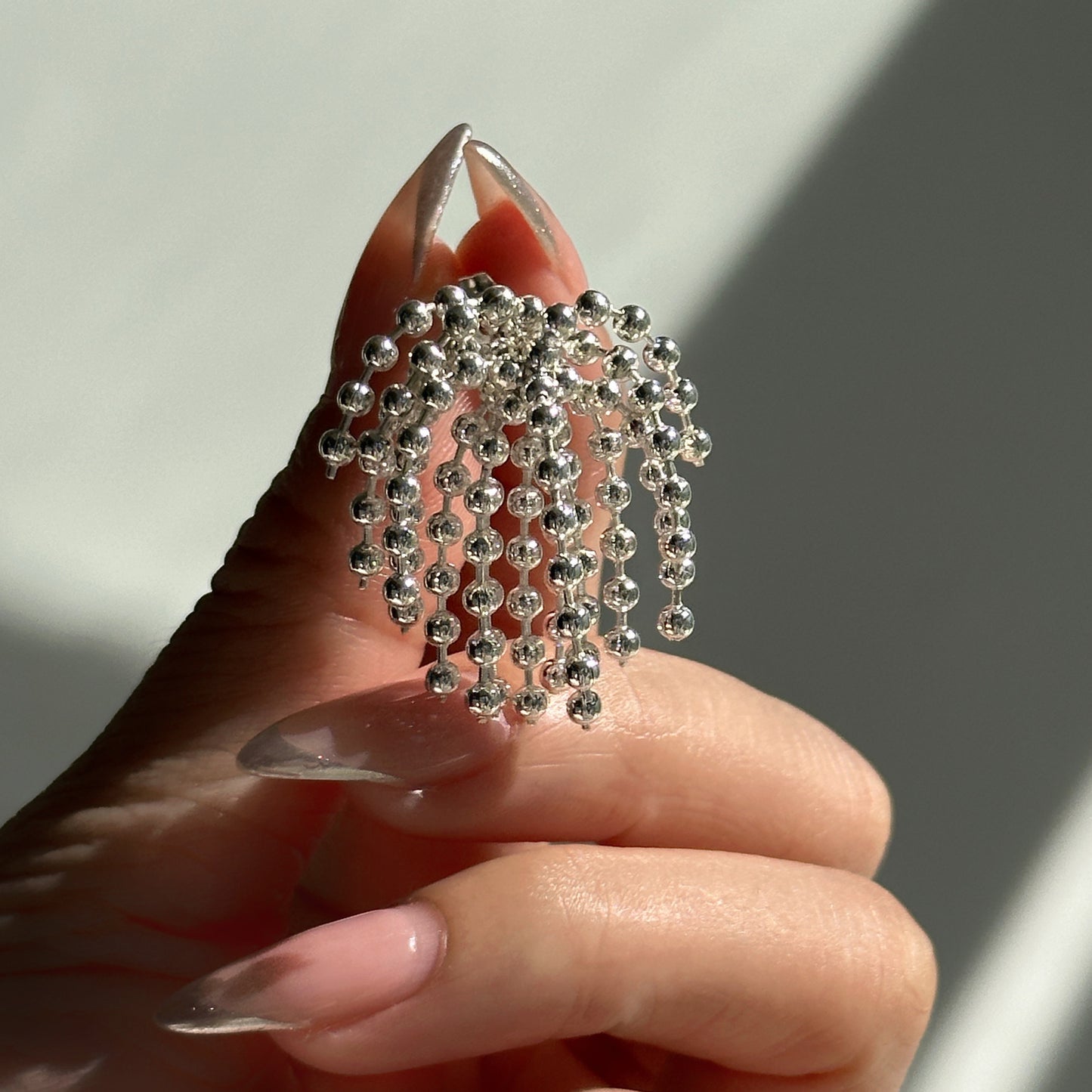 Polished bead fringed earrings