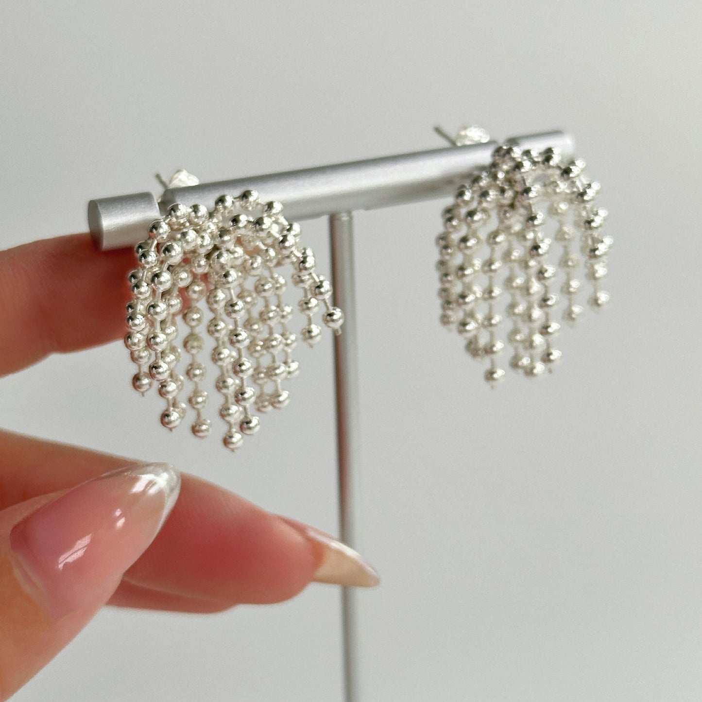 Polished bead fringed earrings